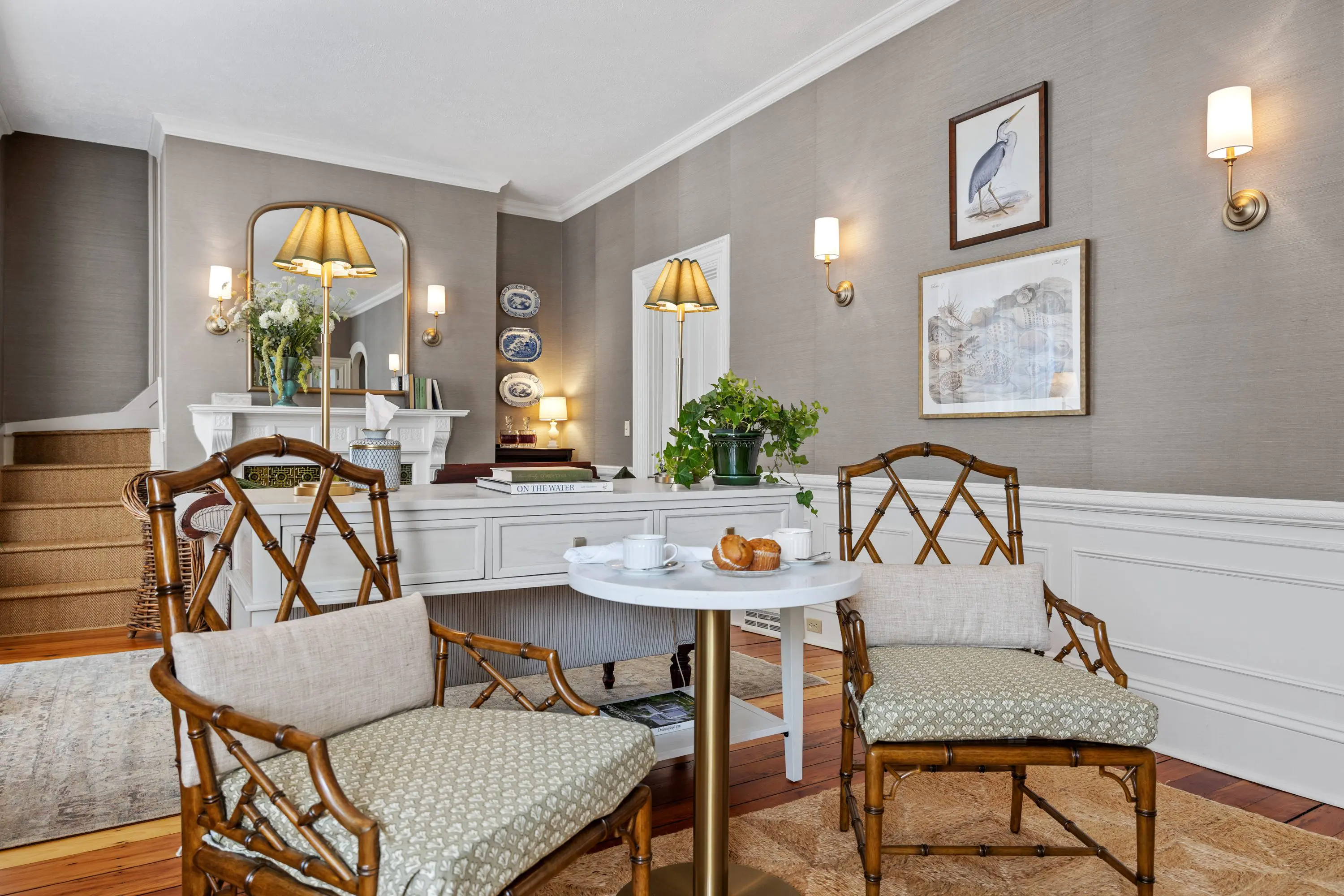 Elegant vintage-style sitting area with classic chairs and a round table.
