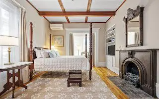 Victorian room with fireplace and flowers.